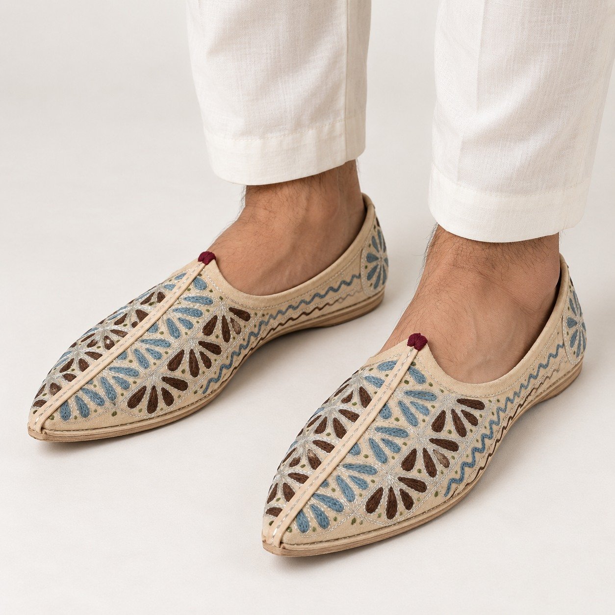 MyMarwar beige, light blue and brown mojari for men with fern leaf embroidery, worn with an ethnic outfit