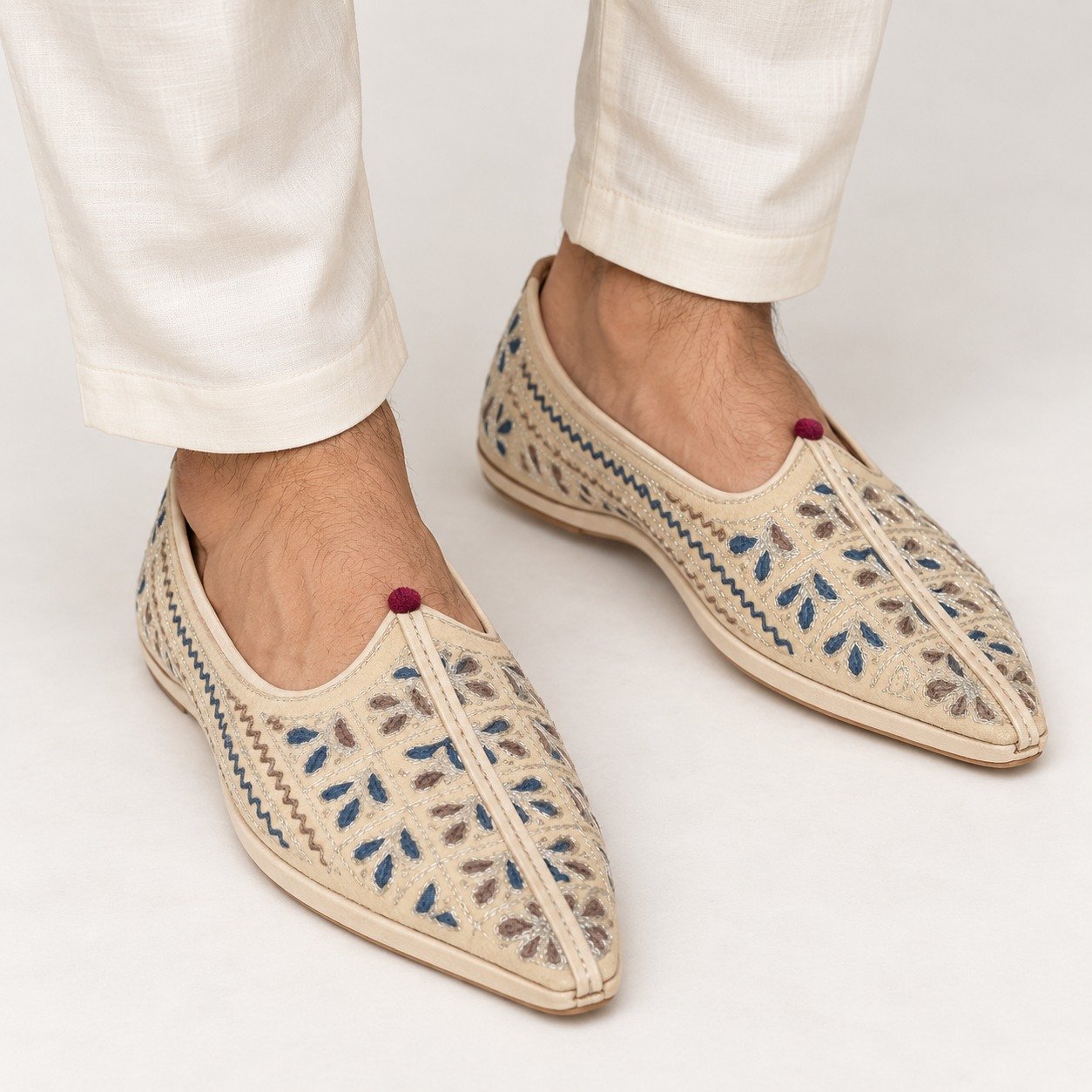 MyMarwar beige, blue and brown mojari for men with small floral leaf embroidery, worn with an ethnic outfit