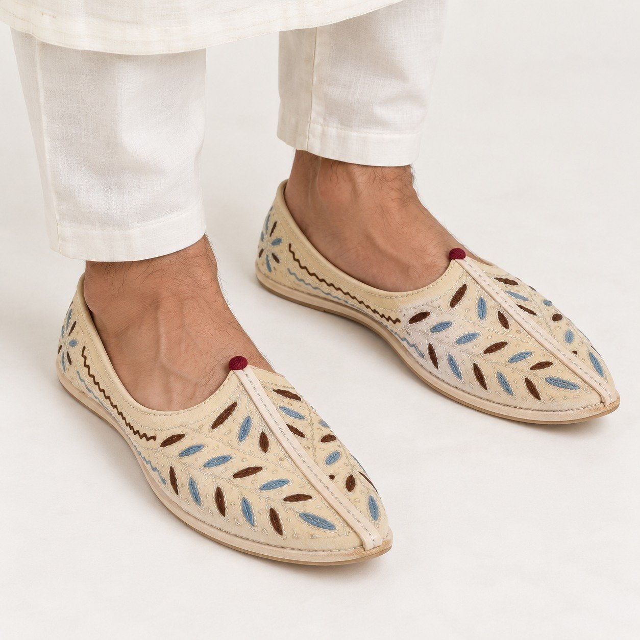 MyMarwar beige, blue and brown mojari for men with scattered leaf embroidery, worn with an ethnic outfit