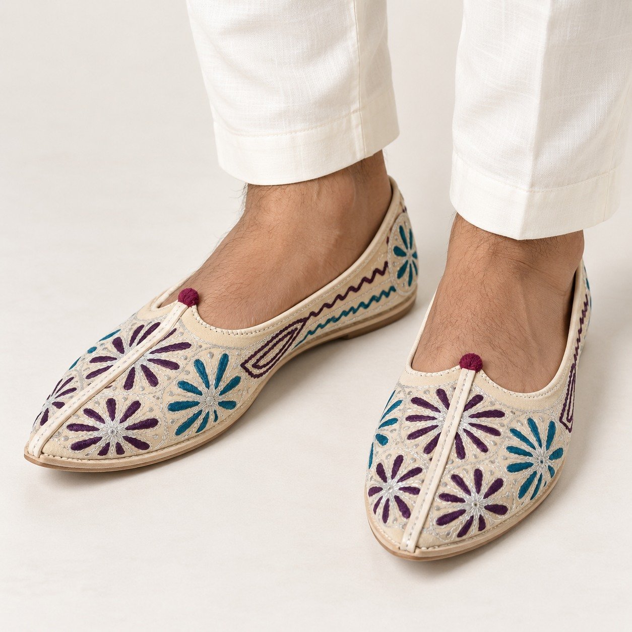 MyMarwar beige, plum and teal mojari for men with large flower embroidery, worn with an ethnic outfit