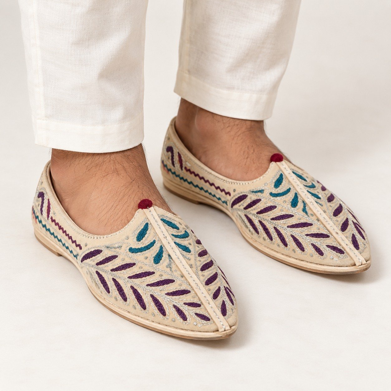 MyMarwar beige, plum and teal mojari for men with elongated leaf embroidery, worn with an ethnic outfit