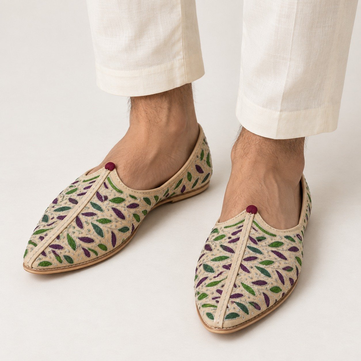 MyMarwar beige, purple and green mojari for men with purple and green leaf embroidery, worn with an ethnic outfit