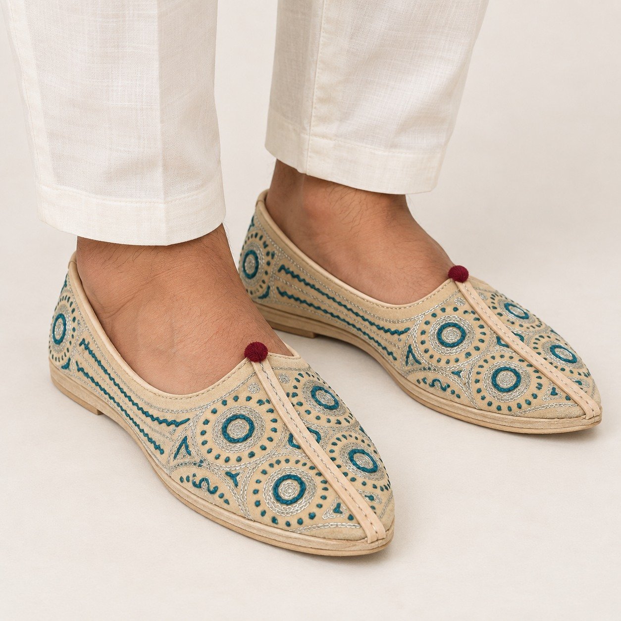 MyMarwar beige, teal and silver tones mojari for men with ring and dot embroidery, worn with an ethnic outfit
